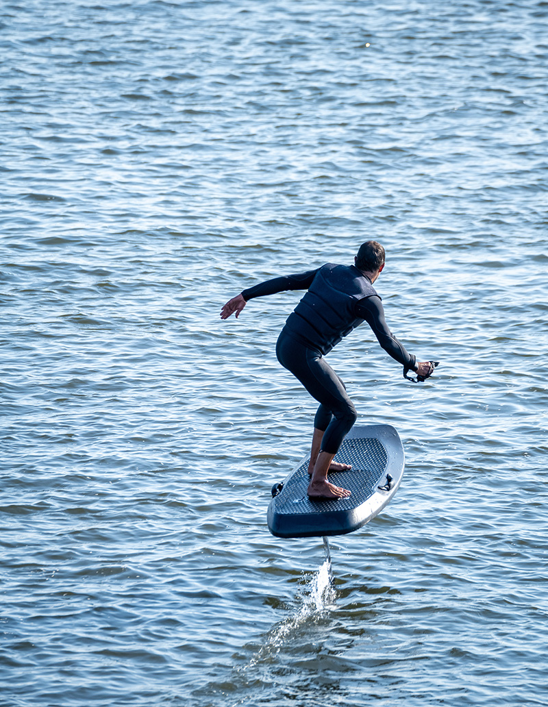 Person riding an e-foil on water